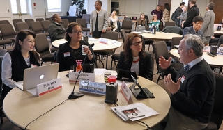 A small group discusses issues at the Directors table