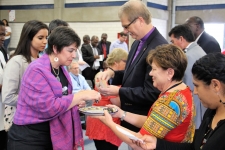 Bishop Kenneth Carter and Rev. Dr. Kim Cape serve communion during closing worship