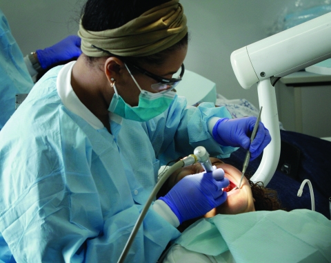 A student dentist performs a procedure on board Meharry Medical College’s mobile dental clinic.