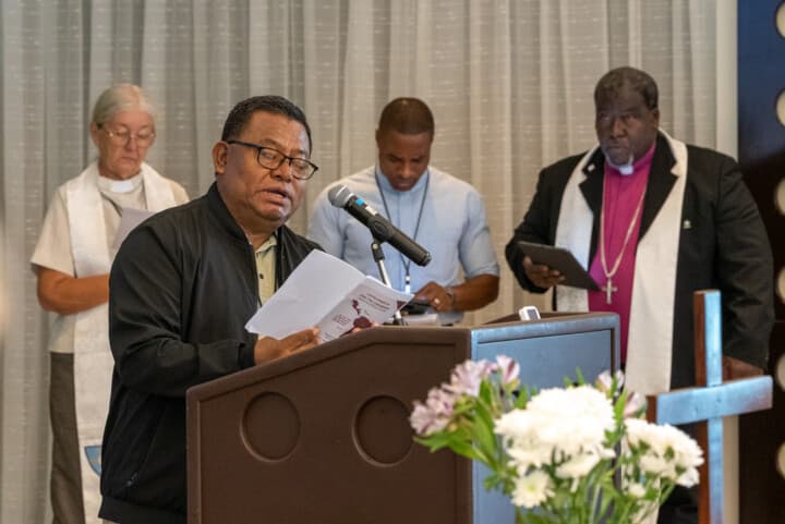 Caption: Bishop Antonio Miguel Trottman Migar of the Panama/Costa Rica District of the Methodist Church of the Caribbean and the Americas (MCCA) speaks to the attendees. In the background, other representatives of the MCCA listen on, including (from left to right) the Rev. Jacqueline H. Liddell (Connexional Secretary), Bishop Damien E. Hughes and Bishop Juan M. Simpson, district president of the Panama/Costa Rica District. Photo: Adam Bowers 