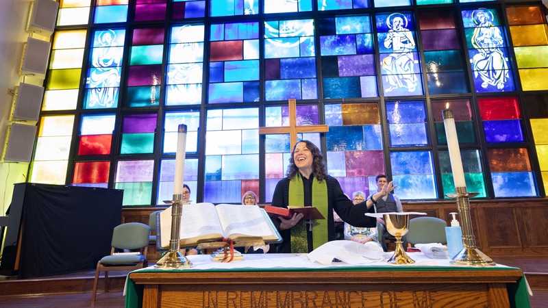 5-7-26-preaching The Rev. Colleen Bookter blesses the elements of Holy Communion during worship at St. Luke’s United Methodist Church in New Orleans. Photo by Mike DuBose, UM News.