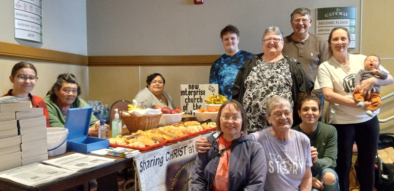 9-29-26-Truck-Stop-devotion Volunteers serve travelers and employees at a hospitality table stocked with refreshments, devotionals, and care packages. Through weekly Bible studies and an ongoing presence at the travel plaza, Rev. Bruce Maxwell, a UMEA chaplain, creates opportunities for fellowship and spiritual support. Photo by Bruce Maxwell